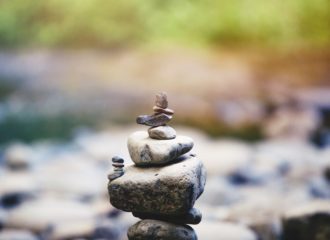 stacked-rocks-by-a-stream